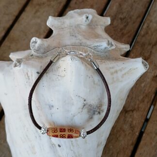 Kinder Armband mit dunkelbrauem Lederband ovaler indianischer Holzperle zwei Metallperlen und Karabinerverschluss
