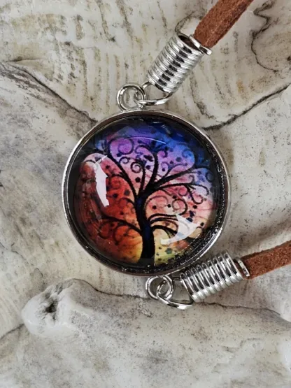 Lederarmband mit Cabochonperle Armkette Armband mit hellbraunen Lederbändern 20mm Cabochon Glasperle mit schwarzem Lebensbaum auf Abendstimmung Hintergrund rot gelb violett